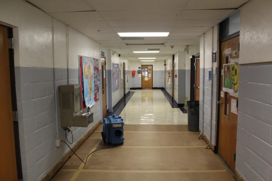 The foreign language hallway in the main building of the high school in which old tiles meet new temporary flooring.