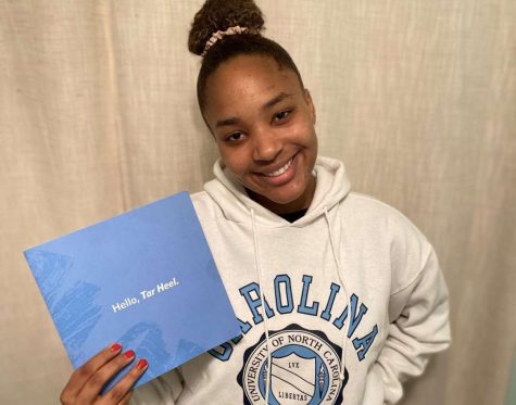 Madison Lawrence smiles and shows off her University of North Carolina college gear. 