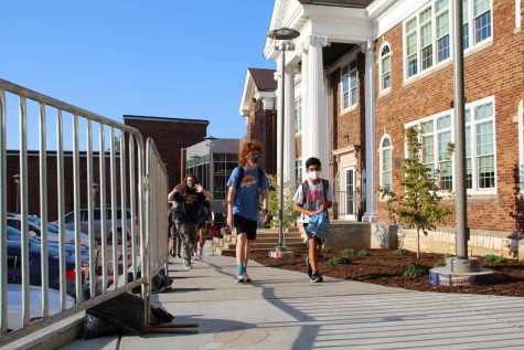 Freshmen Nicholas Reeds and Zach Nelson walk towards the new high school entrance together. 