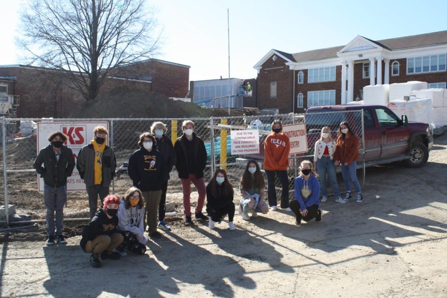 The 2020-2021 Journalism staff poses in front of the high school while it was under construction. 
