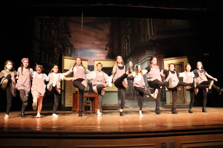 The middle school orphans of Annie break out into song and dance.