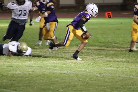 Trento Mitchell (11) runs the ball. 