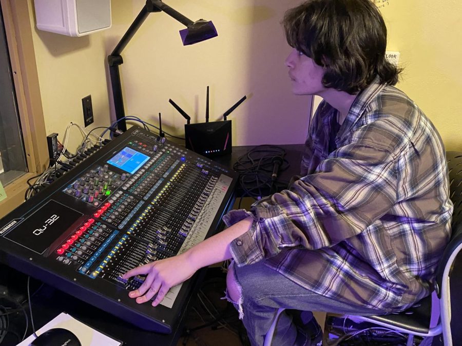 Nola Buehler controls the soundboard during the dress rehearsal for the play Arsenic and Old Lace.