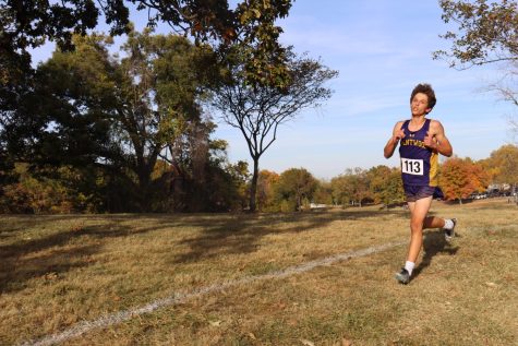 Logan Hawkins is pictured running in a cross country meet. 