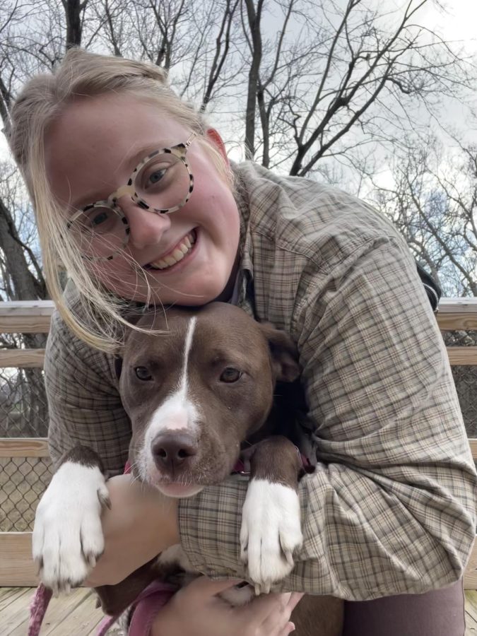 Amelia Ayotte hugs her newest college roommate, Juno, a one-year-old Pit Bull rescue pup.