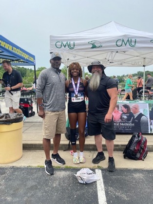 Nija Hayes shows off her  6th place medal, with Coach Long on the right and Coach Finley on the left.