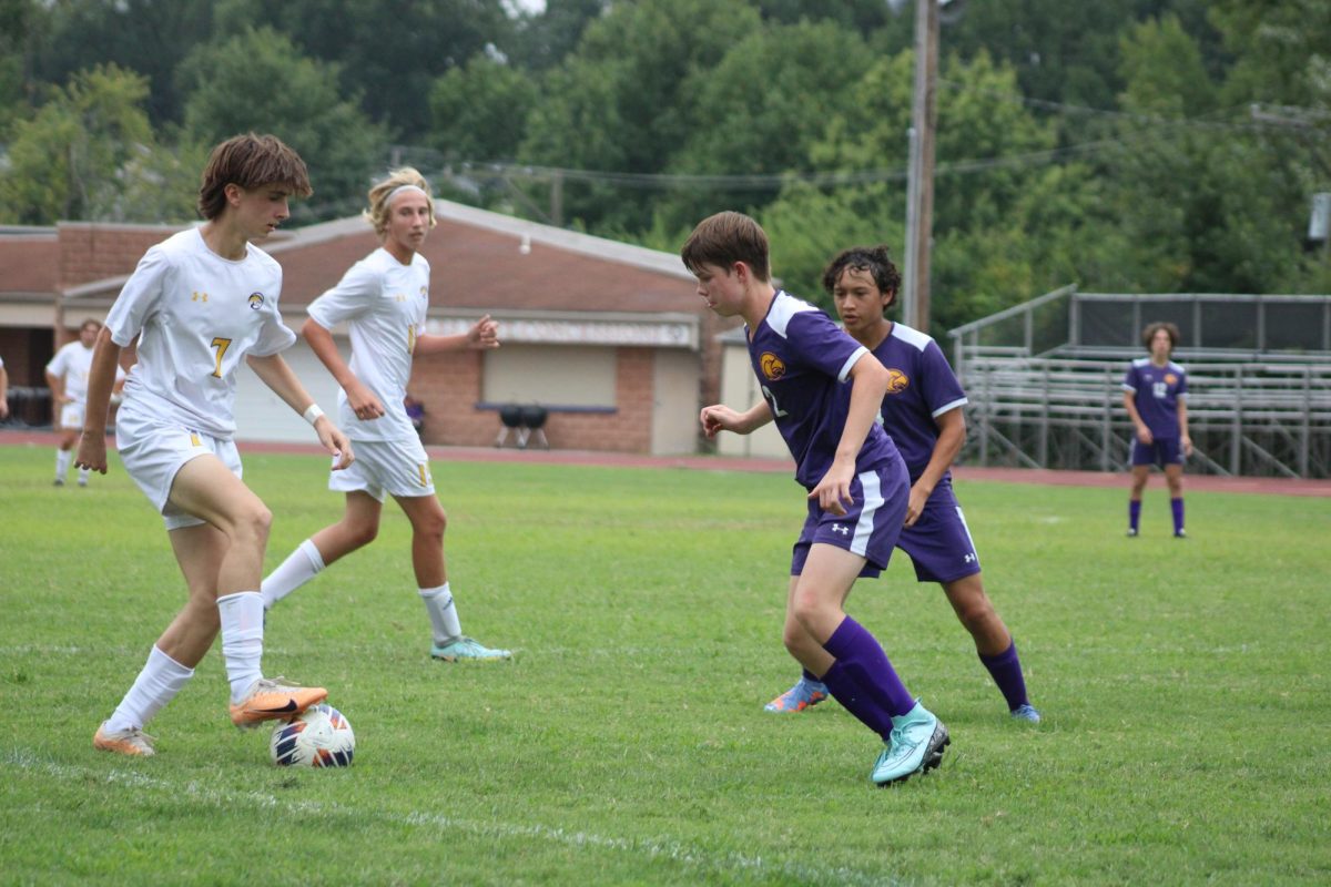 Freshman Will Spencer defends the ball in their game against Afton.