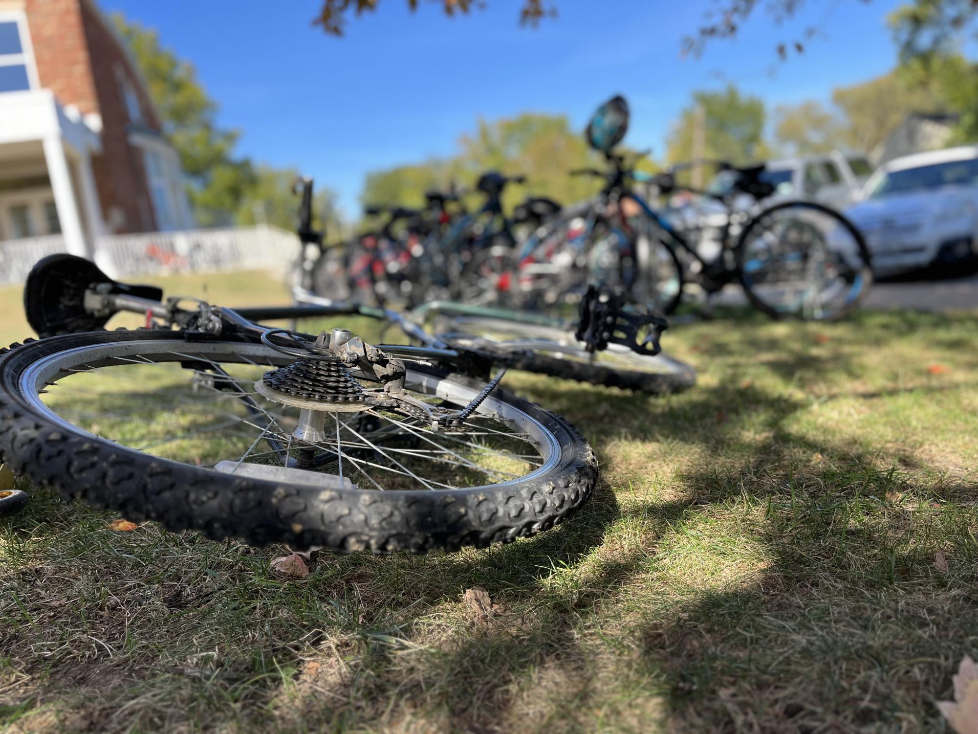 A bike lays on the ground unlocked behind the filled bike racks of Brentwood High School. No space for it to be locked up, it was thrown on the ground in a hurry. Easily ready to be taken and/or stolen.