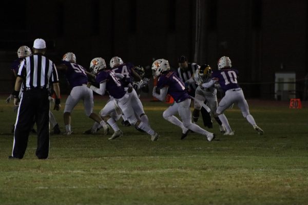 Trenton Mitchell (12) runs down the line of people with the help of our offensive line!