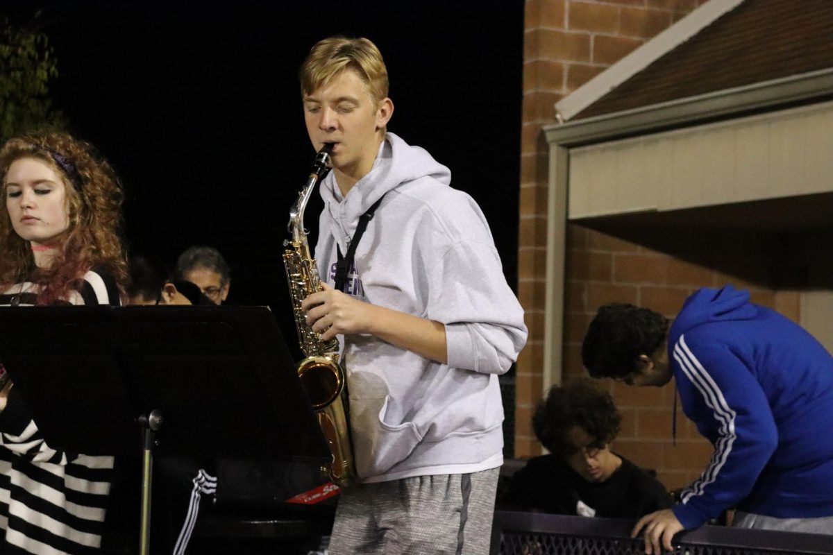 Senior Will Schuering soothingly serenades fans at the Homecoming football game this year. 