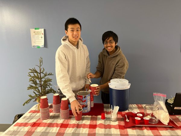 Sophomores Alex Tung and Rohan Dixit happily run the Hot Chocolate Stand for the Mental Awareness Club. You can see all of the ingredients they use to prep the hot chocolate all lying on the table ready to be used. 