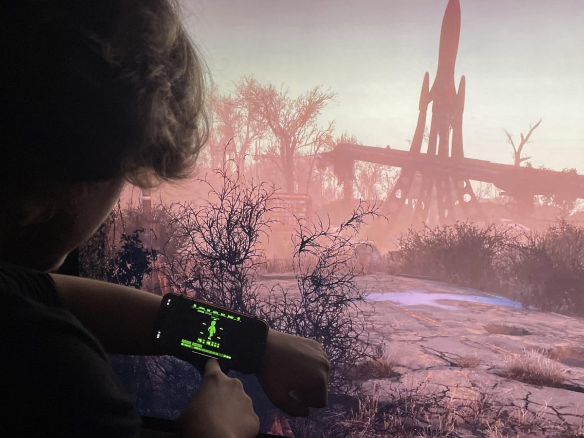 Walter Torres (12) uses a Pip Boy in the wastelands of Fallout.