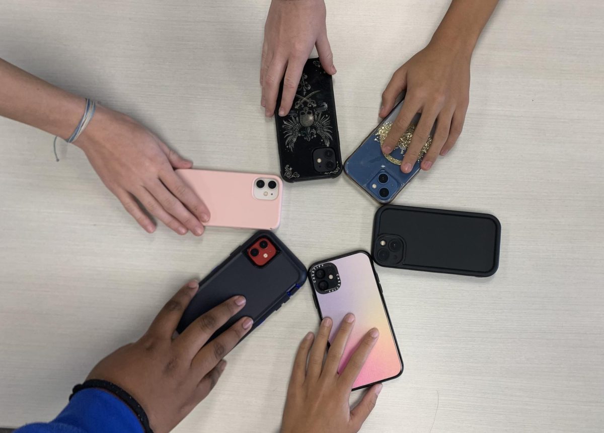 Students reaching for their phones.