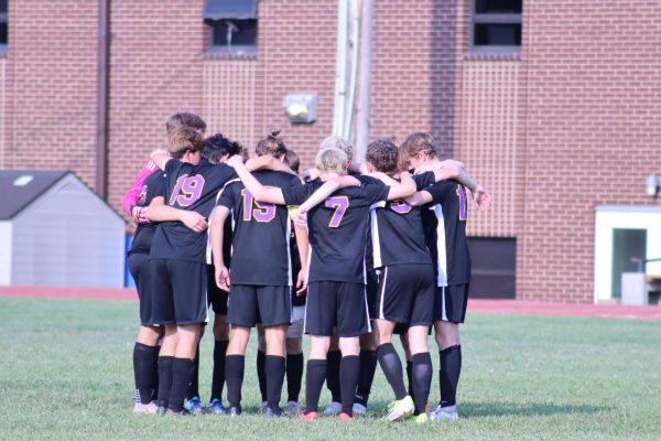 The varsity team comes in for a huddle at its Sept. 10th game against Maplewood. 