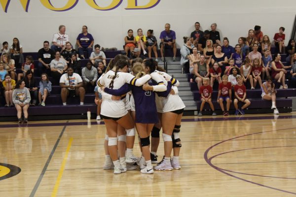 The Brentwood Volleyball team huddles together before they start their match.