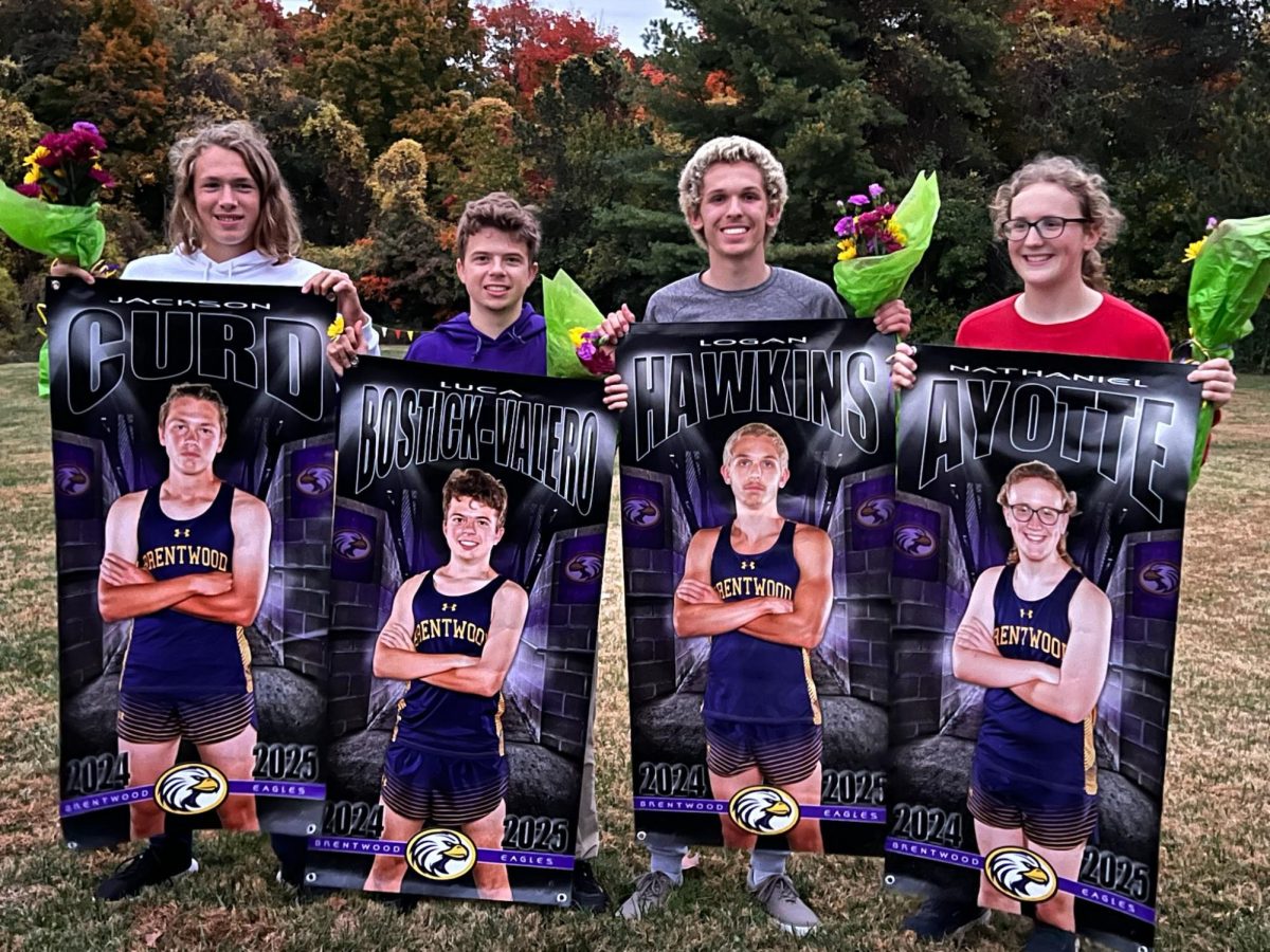 Cross-country seniors pose with their banners after their meet. 