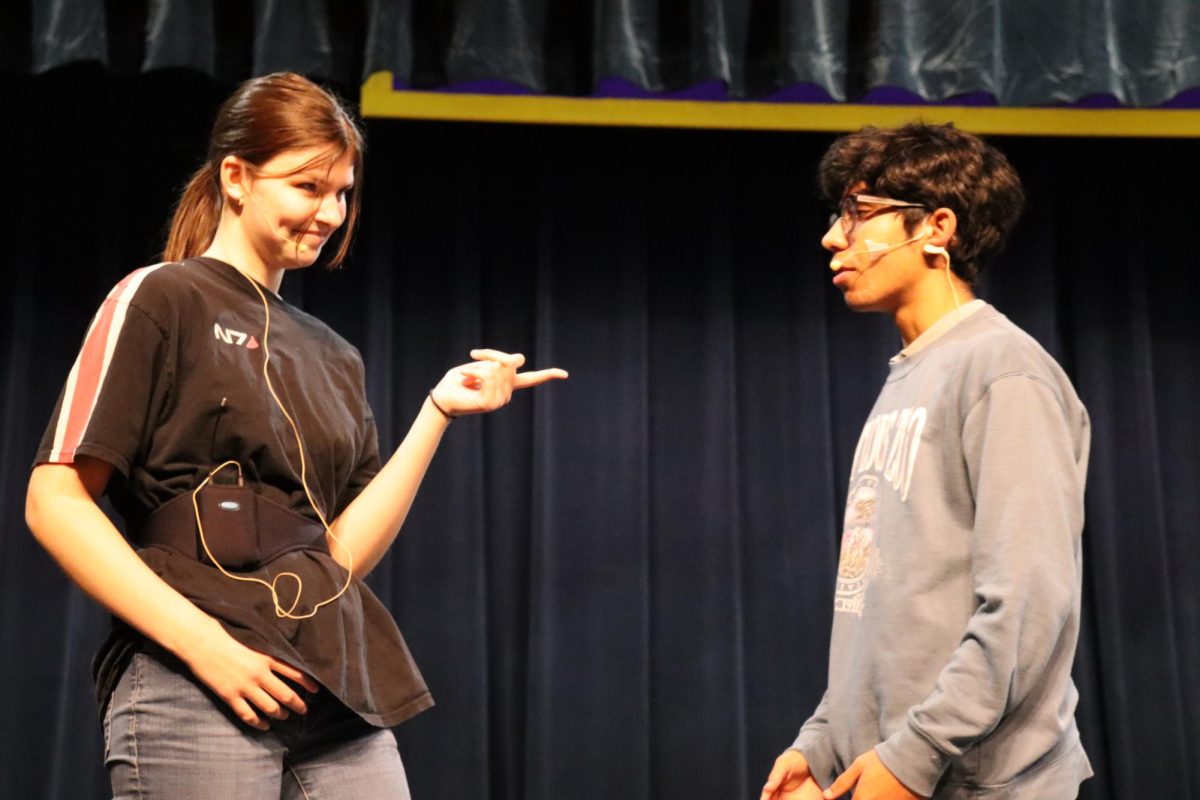 Junior Lizzy Butler and senior Zach Nelson practice at rehearsal.