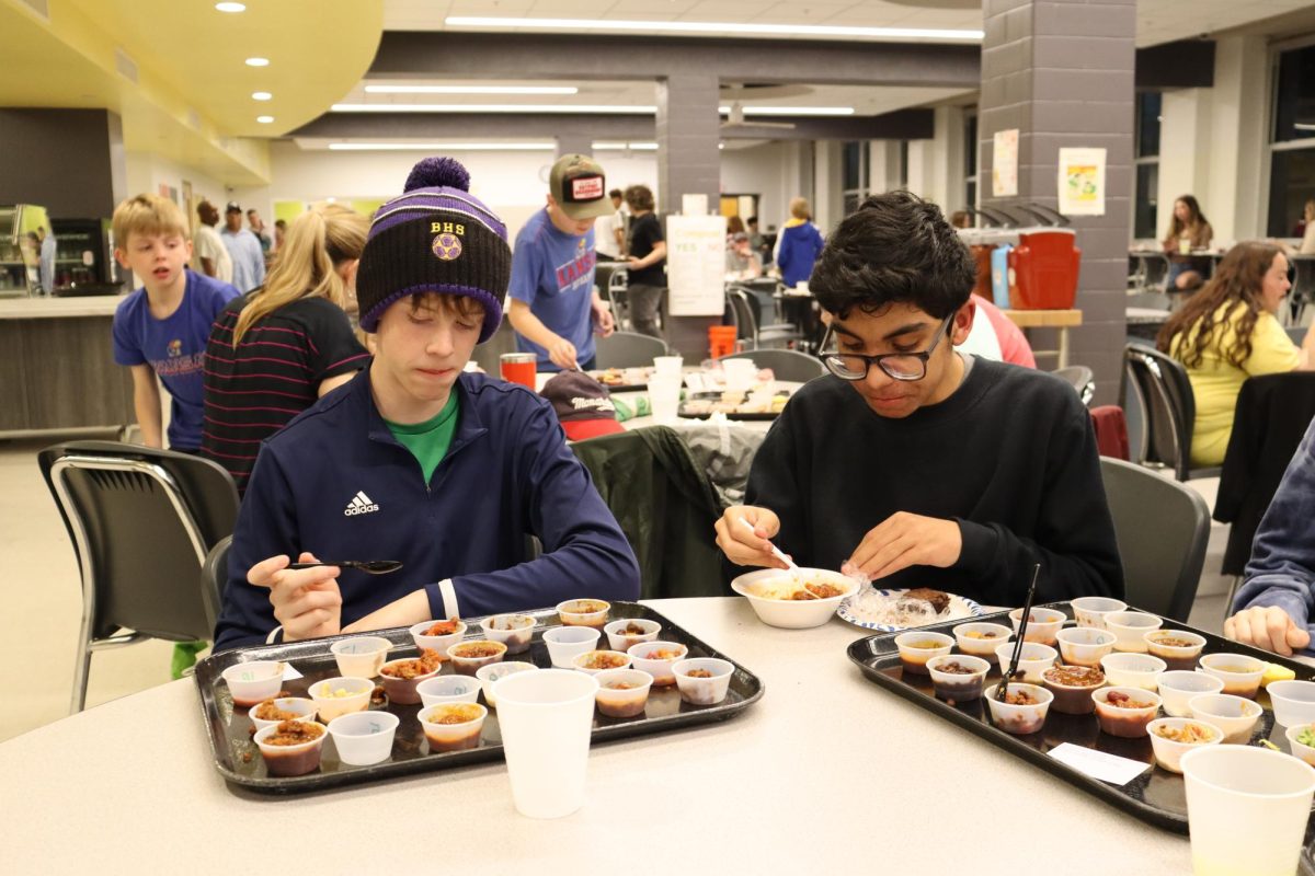 Junior Tyler Nelson (left) and senior Zachary Nelson try all of last year's chili cook-off samples.