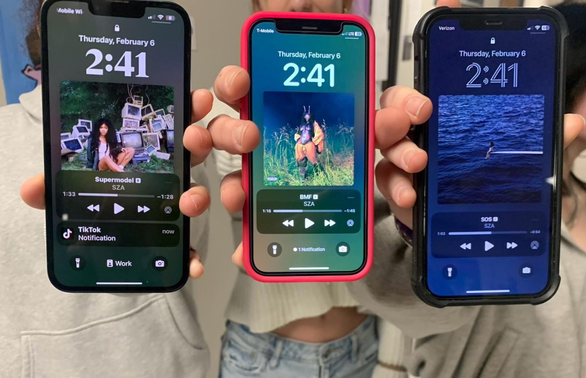 Three students listen to various SZA albums.