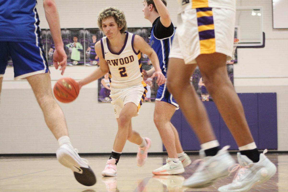 Logan Hawkins (12) dribbling the ball.