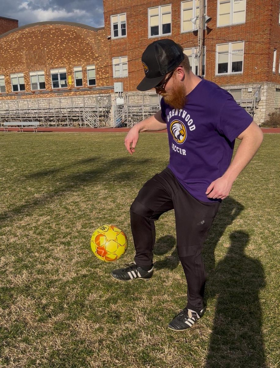 Girls soccer coach, Ryan Limb demonstrates kick ups. 