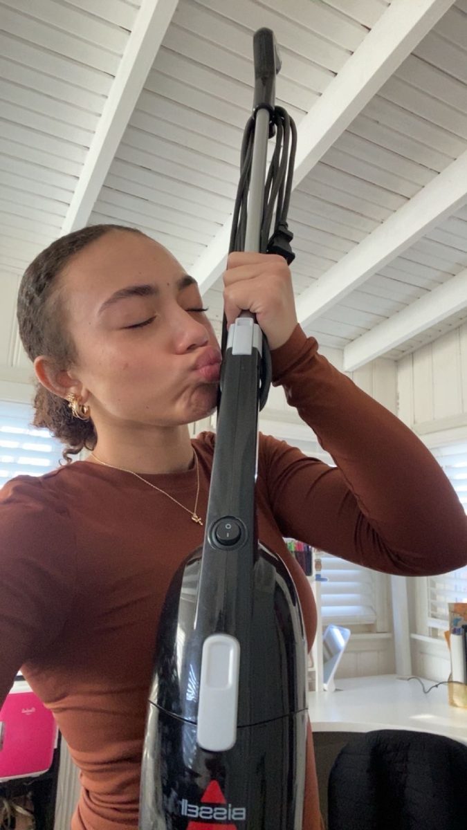 Geniyah Johnson poses with the vacuum that she got as a Christmas gift.