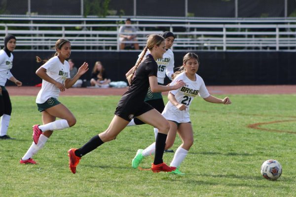 Junior Kensington Curd (sophomore in this photo) races after the ball in a last season.