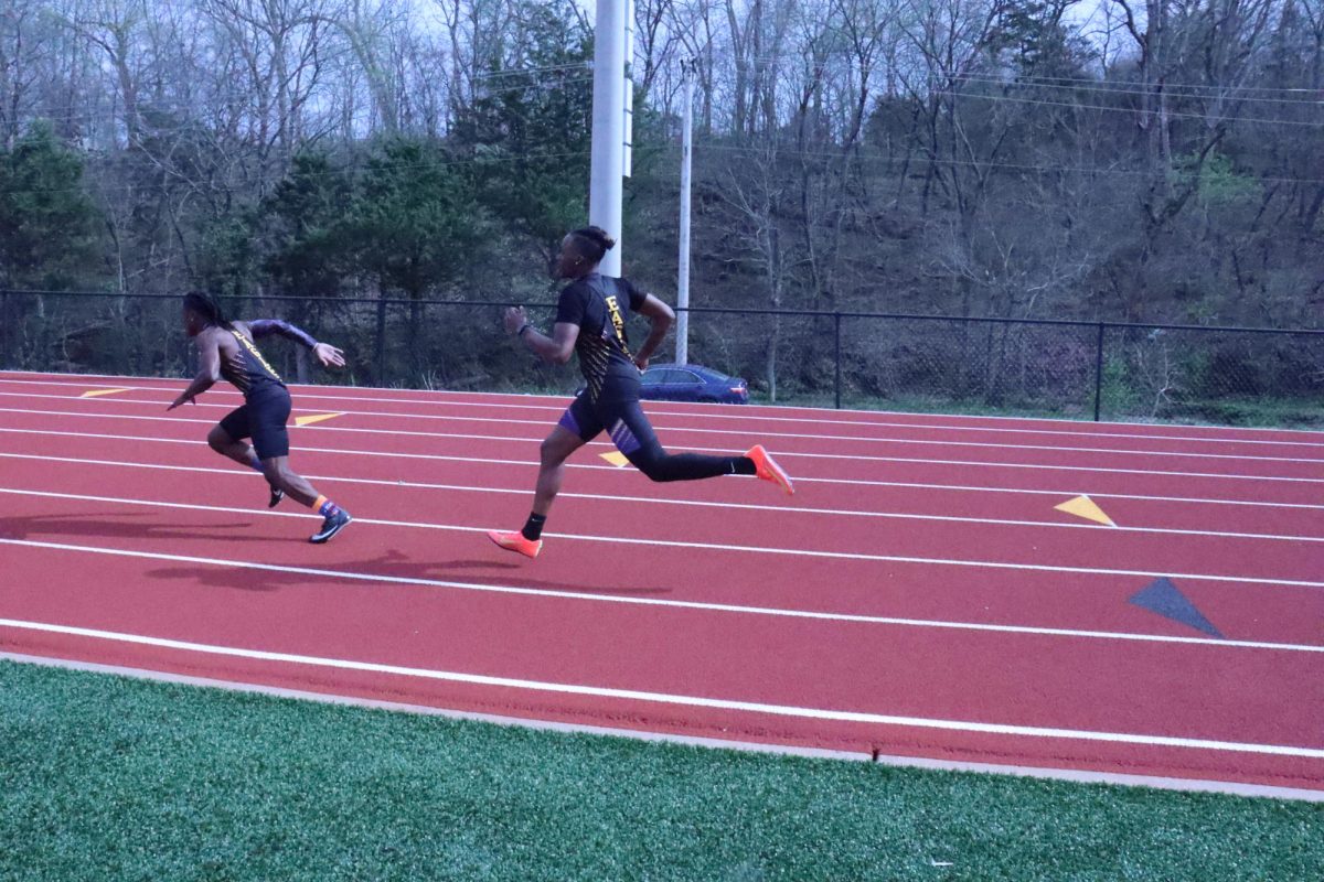 Tyler Taylor passes the baton off to Jessie Lane III in the 4x100 meter relay.
